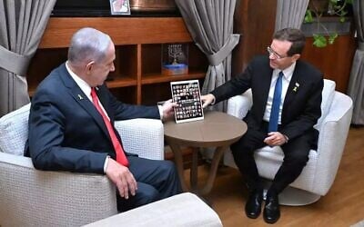 President Isaac Herzog (right) meets with Prime Minister Benjamin Netanyahu in Jerusalem, July 6, 2025. On the table is  a picture of the hostages held in Gaza. (Haim Zach/GPO)
