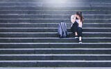 Illustrative: An upset student sits in a school yard (iStock by Getty Images)