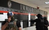 US Immigration and Customs Enforcement (ICE) agents look over lists of names, and their hearing times and locations, inside the Federal Plaza courthouse before making arrests on June 27, 2025, in New York. (Bryan R. Smith/AFP)