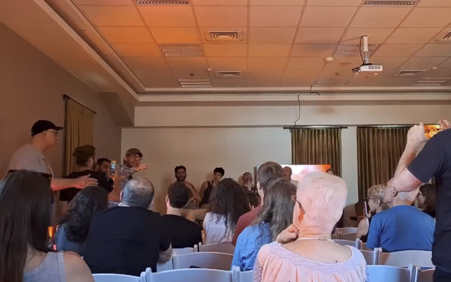 Right-wing activist Shai Glick is escorted out of a panel at the Jerusalem Film Festival on July 20, 2025. (Amy Spiro/Times of Israel) Right-wing activist Shai Glick is escorted out of a panel at the Jerusalem Film Festival on July 20, 2025. (Amy Spiro/Times of Israel)