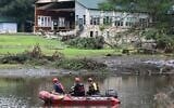A search and rescue team looks for people along the Guadalupe River near a damaged building at Camp Mystic in Hunt, Texas, on July 7, 2025, following severe flash flooding that occurred during the July 4 holiday weekend. (RONALDO SCHEMIDT / AFP)