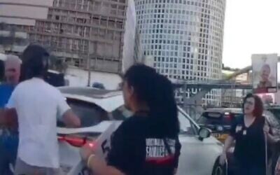 Screen capture from video of a motorcyclist attacking an elderly protester, left, at a rally for a hostage and ceasefire deal in Tel Aviv, July 21, 2025. (X: Used in accordance with Clause 27a of the Copyright Law)