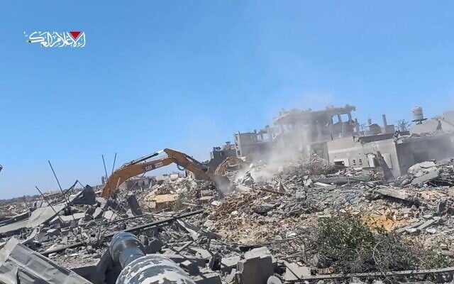 This screenshot from a Hamas video published July 10, 2025, shows terror operatives attacking Israeli troops carrying out demolition work in southern Gaza's Khan Younis, on July 9, 2025. (Hamas, via Telegram)