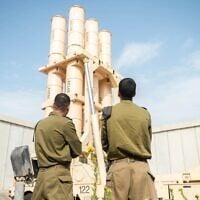 Illustrative: Israeli Air Force soldiers pose in front of an Arrow air defense system battery, in a photo issued by the IDF on June 26, 2025. (Israel Defense Forces)