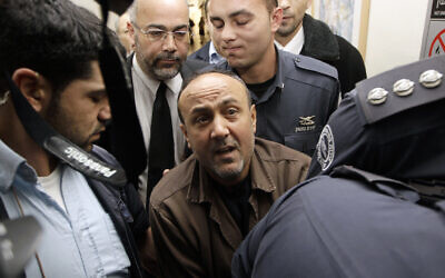 Jailed Fatah leader Marwan Barghouti (C) is accompanied by Israeli prison guards after a hearing at Jerusalem Magistrate's Court, January 25, 2012. (REUTERS/Ammar Awad) Jailed Fatah leader Marwan Barghouti (C) is accompanied by Israeli prison guards after a hearing at Jerusalem Magistrate's Court, January 25, 2012. (REUTERS/Ammar Awad)