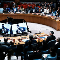 Ilay David is displayed on screen as he shows a picture of his brother of Evyatar David, who is held hostage by Hamas in Gaza, during a Security Council meeting at UN headquarters in New York City, August 5, 2025. At right, in front row with back to camera, is Israeli Foreign Minister Gideon Sa'ar. (REUTERS/Eduardo Munoz)