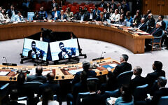 Ilay David is displayed on screen as he shows a picture of his brother of Evyatar David, who is held hostage by Hamas in Gaza, during a Security Council meeting at UN headquarters in New York City, August 5, 2025. At right, in front row with back to camera, is Israeli Foreign Minister Gideon Sa'ar. (REUTERS/Eduardo Munoz)