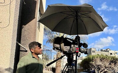 Palestinian cameraman Hussam al-Masri, a contractor for Reuters who was killed in an Israeli strike on Nasser Hospital on August 25, 2025, stands next to his camera as he works at the hospital in this undated picture. (REUTERS / Mohammed Salem)