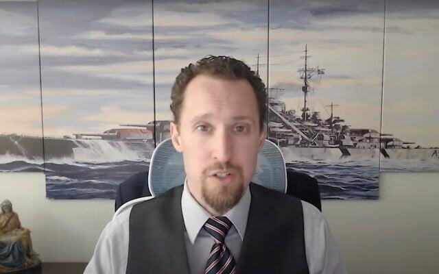 Economist E.J. Antoni is interviewed in front of art depicting the Nazi warship Bismarck, December 9, 2024. In August 2025, President Trump nominated Antoni to lead the Bureau of Labor Statistics. (Screenshot via YouTube/ via JTA)