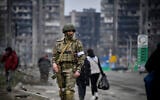 A Russian soldier patrols in a street of Mariupol, in Russian-occupied Ukraine, on April 12, 2022. (Alexander NEMENOV / AFP)