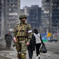 A Russian soldier patrols in a street of Mariupol, in Russian-occupied Ukraine, on April 12, 2022. (Alexander NEMENOV / AFP)