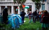 Students stand among tents at a pro-Palestinian, anti-Israel camp set up on the campus of Queen Mary University of London, on May 14, 2024. (BENJAMIN CREMEL / AFP)
