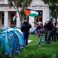 Students stand among tents at a pro-Palestinian, anti-Israel camp set up on the campus of Queen Mary University of London, on May 14, 2024. (BENJAMIN CREMEL / AFP)