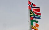 The flags of (from top) Norway, South Africa, Palestine, Ireland, and Spain, are raised at an entrance of Ramallah city in the West Bank on May 28, 2024. (Zain JAAFAR / AFP)