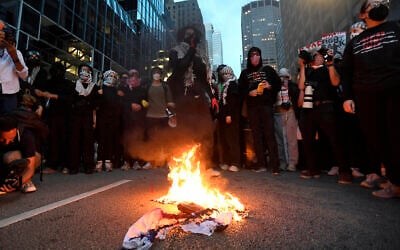 Illustrative: Pro-Palestine, anti-Israel demonstrators burn a US-Israel flag during a protest as the Democratic National Convention takes place in Chicago, Illinois, on August 20, 2024. (Matthew Hatcher/AFP)