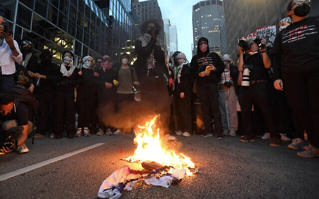 Illustrative: Pro-Palestine, anti-Israel demonstrators burn a US-Israel flag during a protest as the Democratic National Convention takes place in Chicago, Illinois, on August 20, 2024. (Matthew Hatcher/AFP) Illustrative: Pro-Palestine, anti-Israel demonstrators burn a US-Israel flag during a protest as the Democratic National Convention takes place in Chicago, Illinois, on August 20, 2024. (Matthew Hatcher/AFP)