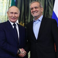 Russian President Vladimir Putin and Iranian President Masoud Pezeshkian shake hands during a meeting at the Kremlin in Moscow on January 17, 2025. (Evgenia Novozhenina/Pool/AFP)