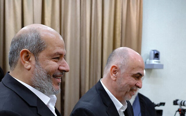 Hamas political bureau chief Khalil al-Hayya, left, seen in Tehran on February 8, 2025. (Photo by KHAMENEI.IR / AFP)