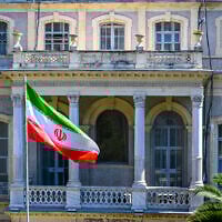 An Iranian flag flutters in front of the Iranian Consulate, where Iranian diplomats meet counterparts from Germany, Britain and France for renewed nuclear talks, in Istanbul, Turkey, on July 25, 2025. (Yasin AKGUL / AFP)