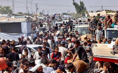 Palestinians carry personal belongings in the Mawasi area of Rafah in the southern Gaza Strip on July 28, 2025. (AFP)