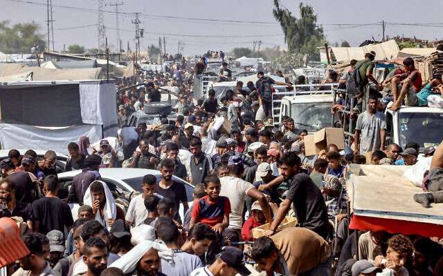 Palestinians carry personal belongings in the Mawasi area of Rafah in the southern Gaza Strip on July 28, 2025. (AFP)