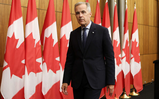 Canadian Prime Minister Mark Carney leaves after speaking during a press conference after a cabinet meeting to discuss both trade negotiations with the US and the situation in the Middle East, at the National Press Theatre in Ottawa, Ontario, Canada on July 30, 2025. (Dave Chan / AFP) Canadian Prime Minister Mark Carney leaves after speaking during a press conference after a cabinet meeting to discuss both trade negotiations with the US and the situation in the Middle East, at the National Press Theatre in Ottawa, Ontario, Canada on July 30, 2025. (Dave Chan / AFP)
