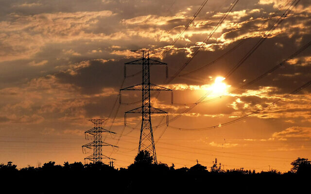 High voltage electrical transmission towers are pictured at sunset in western Tehran, Iran, on August 2, 2025. (ATTA KENARE / AFP)
