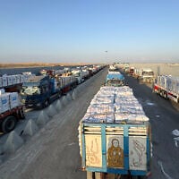 Trucks loaded with humanitarian aid await permission on the Egyptian side of the Rafah crossing with the Gaza Strip, August 3, 2025. (AFP)