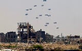 Aid pallets are dropped from a military plane over Nuseirat in the central Gaza Strip during an airdrop mission on August 4, 2025. (AFP)