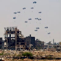 Aid pallets are dropped from a military plane over Nuseirat in the central Gaza Strip during an airdrop mission on August 4, 2025. (AFP)