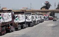 Trucks loaded with humanitarian aid await permission on the Egyptian side of the Rafah crossing with the Gaza Strip, to enter the Palestinian territory on August 6, 2025. (AFP)