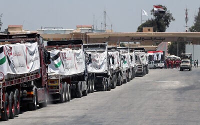 Trucks loaded with humanitarian aid await permission on the Egyptian side of the Rafah crossing with the Gaza Strip, to enter the Palestinian territory on August 6, 2025. (AFP)