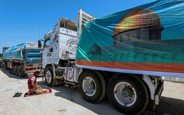 A driver prays as trucks loaded with humanitarian aid await permission on the Egyptian side of the Rafah border crossing with the Gaza Strip, to enter the territory on August 6, 2025. (AFP) A driver prays as trucks loaded with humanitarian aid await permission on the Egyptian side of the Rafah border crossing with the Gaza Strip, to enter the territory on August 6, 2025. (AFP)