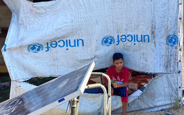 A boy sits next to a tent at a camp housing displaced Palestinians in the Mawasi area in Khan Younis in the southern Gaza Strip, on August 7, 2025. (AFP) A boy sits next to a tent at a camp housing displaced Palestinians in the Mawasi area in Khan Younis in the southern Gaza Strip, on August 7, 2025. (AFP)