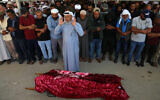 Palestinians pray during the funeral of 31-year-old Awdah Hathaleen, in the Masafer Yatta area south of Hebron in the West Bank on August 7, 2025. (Mosab Shawer / AFP)