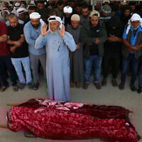 Palestinians pray during the funeral of 31-year-old Awdah Hathaleen, in the Masafer Yatta area south of Hebron in the West Bank on August 7, 2025. (Mosab Shawer / AFP)