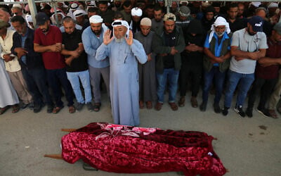 Palestinians pray during the funeral of 31-year-old Awdah Hathaleen, in the Masafer Yatta area south of Hebron in the West Bank on August 7, 2025. (Mosab Shawer / AFP)
