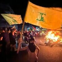 Supporters of Lebanon's Hezbollah terror group block the streets with burning tires as they rally in cars and motorbikes to protest the government's endorsement of a plan to disarm it, in Beirut's southern suburbs, early on August 8, 2025. (Ibrahim AMRO / AFP)