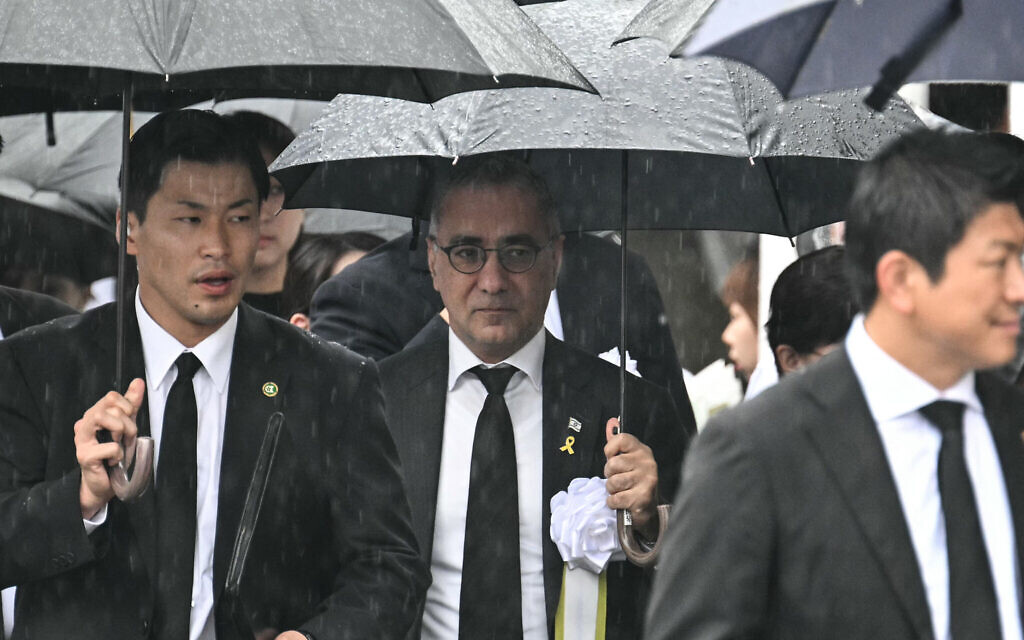 Israel's ambassador to Japan Gilad Cohen (C) arrives to attend the annual memorial ceremony for the victims at the Peace Park in Nagasaki on August 9, 2025, to mark the 80th anniversary of the atomic bombing during WWII.  (Photo by Philip FONG / AFP)