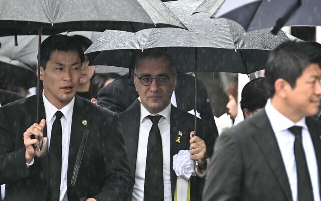 Israel's ambassador to Japan Gilad Cohen (C) arrives to attend the annual memorial ceremony for the victims at the Peace Park in Nagasaki on August 9, 2025, to mark the 80th anniversary of the atomic bombing during WWII.  (Photo by Philip FONG / AFP)