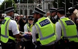 A protester is carried away by police officers at a 'Lift The Ban' demonstration in support of the proscribed group Palestine Action at Parliament Square, central London, on August 9, 2025. (HENRY NICHOLLS / AFP)