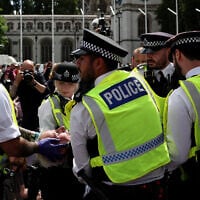 A protester is carried away by police officers at a 'Lift The Ban' demonstration in support of the proscribed group Palestine Action at Parliament Square, central London, on August 9, 2025. (HENRY NICHOLLS / AFP)