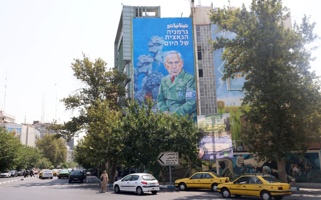 A recently unveiled billboard bearing the portrait of Prime Minister Benjamin Netanyahu with text in Persian reading 'Hitanyahu' and text in Hebrew reading 'Germany's Nazi of today; at Palestine Square in central Tehran on August 11, 2025. (ATTA KENARE / AFP)