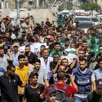 Mourners march with the bodies of the Al Jazeera journalists who were killed in an overnight Israeli strike on their tent in Gaza City, from Al-Shifa hospital to their burial at the Sheikh Radwan cemetery in Gaza City on August 11, 2025. (Omar AL-QATTAA / AFP)