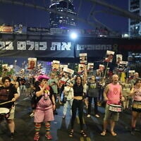 Protestors block a road during an anti-government rally calling for action to secure the release of Israeli hostages held captive since the October 7, 2023, Hamas-led attack in Tel Aviv on August 12, 2025. (Jack GUEZ / AFP)