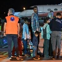 Medics and health personnel welcome Palestinian children from Gaza and their families brought for medical care at Rome's Ciampino airport. (Andreas SOLARO / AFP)