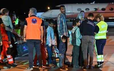 Medics and health personnel welcome Palestinian children from Gaza and their families brought for medical care at Rome's Ciampino airport. (Andreas SOLARO / AFP)