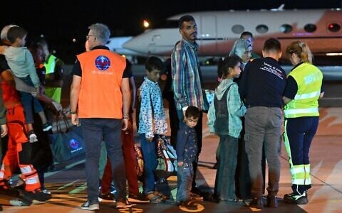 Medics and health personnel welcome Palestinian children from Gaza and their families brought for medical care at Rome's Ciampino airport. (Andreas SOLARO / AFP)