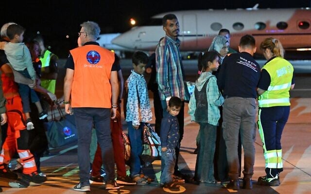 Medics and health personnel welcome Palestinian children from Gaza and their families brought for medical care at Rome's Ciampino airport. (Andreas SOLARO / AFP)