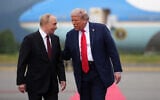 US President Donald Trump (R) walks with Russian President Vladimir Putin as they arrive at Joint Base Elmendorf-Richardson in Anchorage, Alaska, on August 15, 2025. (Andrew Harnik/ Getty Images/ AFP)